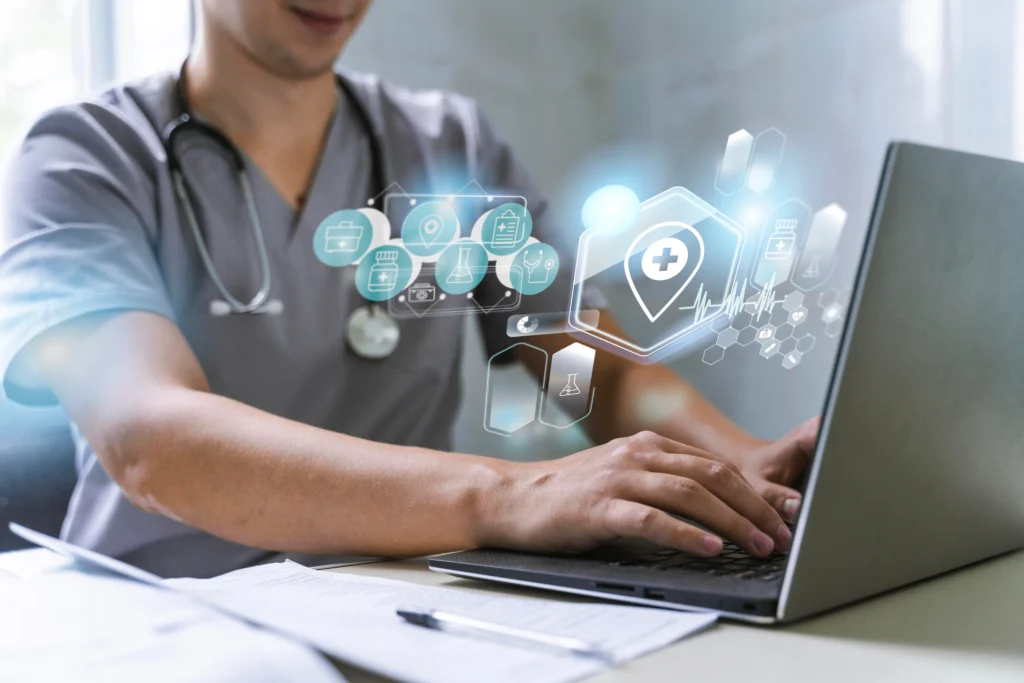 A healthcare professional using laptop with digital medical interface, symbolizing Acucare's AI integration in gastroenterology care.