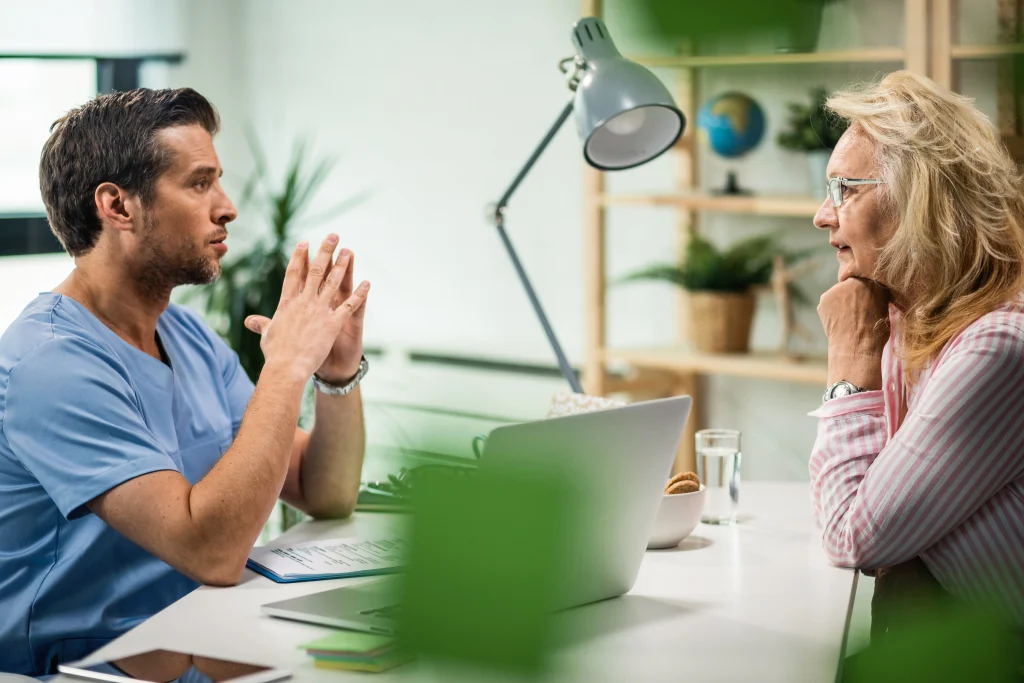 A doctor and patient talk openly, showing how feedback supports patient safety in healthcare.